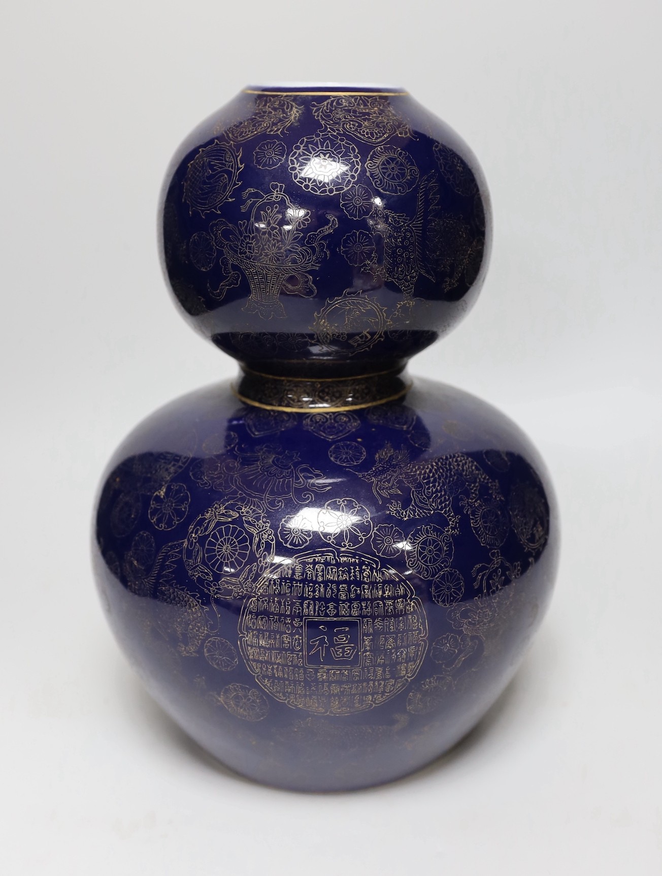 A large Chinese gilt decorated blue glazed double gourd vase, 31cm